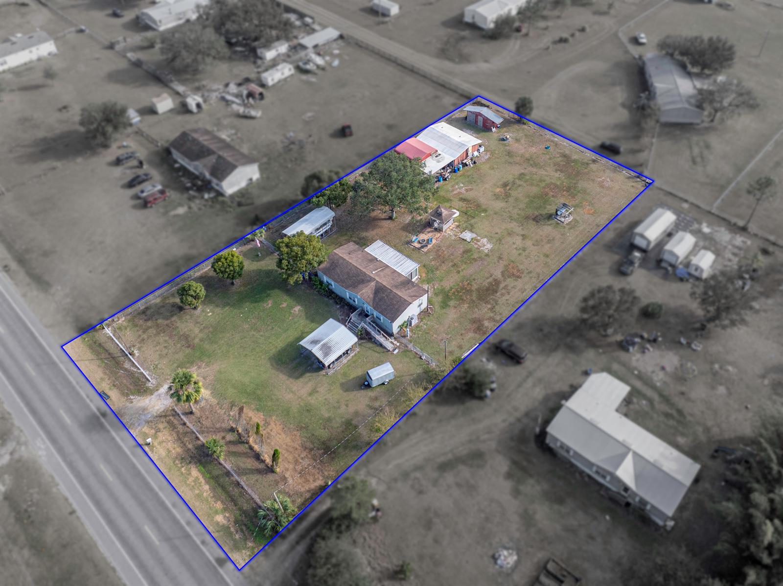 An aerial view shows a residential lot with a house, outbuildings, and trees — 11404 Lithia Pinecrest Road, FL 33547, FL