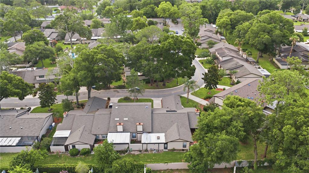 An aerial view shows a residential complex with multiple townhomes, green lawns, and mature trees — 3824 NE 19TH STREET CIRCLE, OCALA, FL