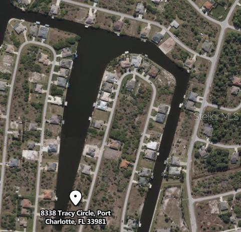 This aerial map shows residential homes situated along a network of canals — 8338 TRACY CIRCLE, PORT CHARLOTTE, FL