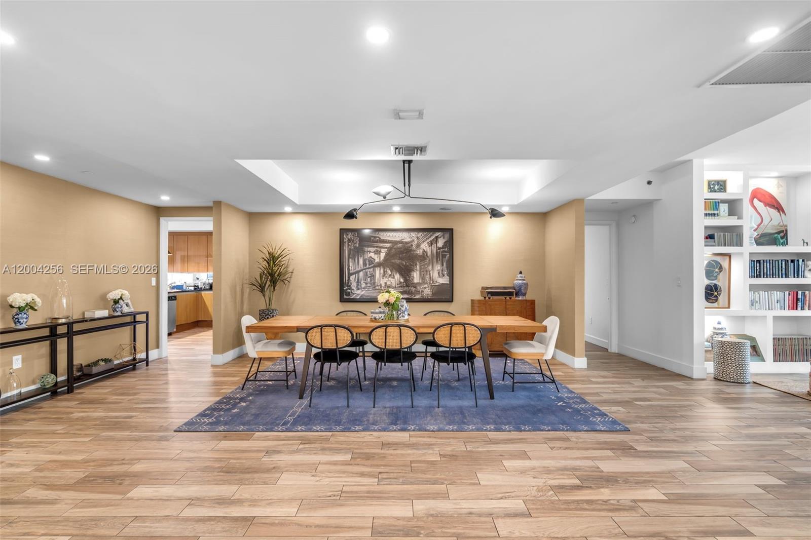 A dining room features a long wooden table, black chairs, and a blue area rug — 791 Crandon Blvd # 302, Key Biscayne FL 33149, KEY BISCAYNE, FL