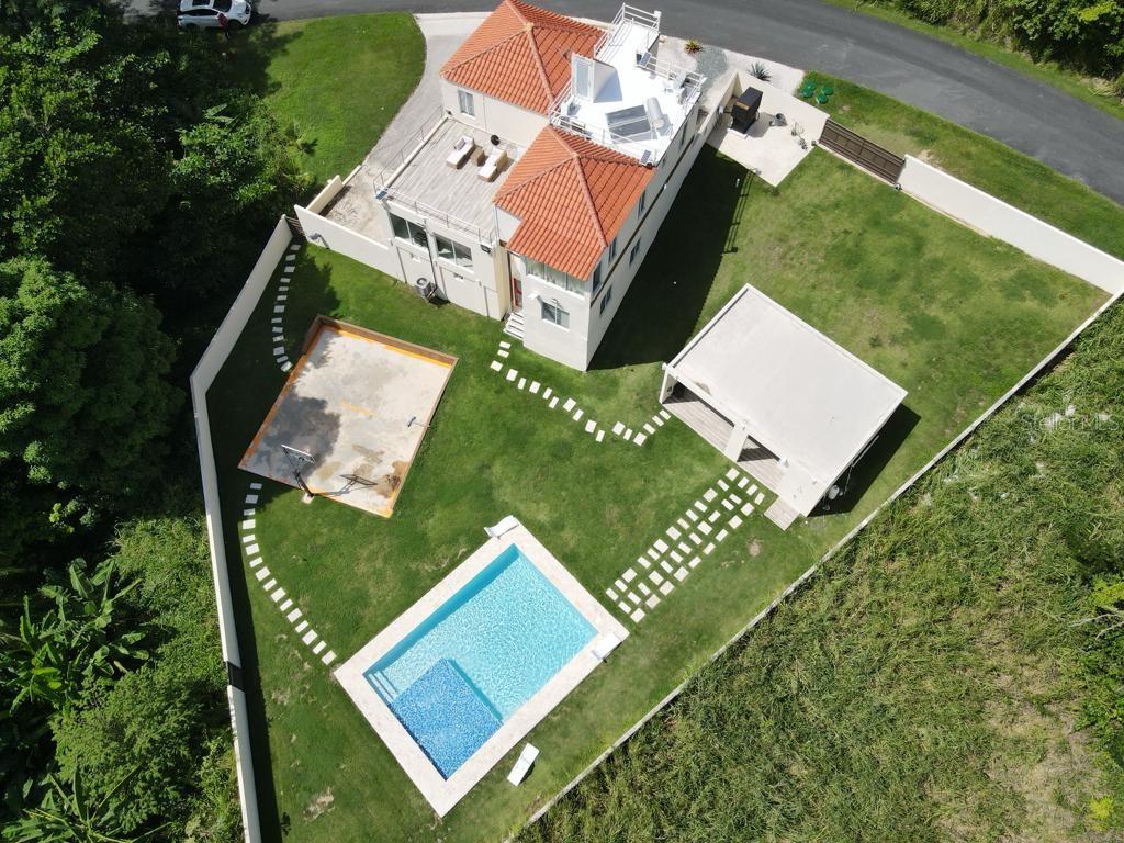 An aerial view of a house with a tiled roof, swimming pool, and detached garage — 40 ROBLE VALLEY UNIT 40, HUMACAO, PR