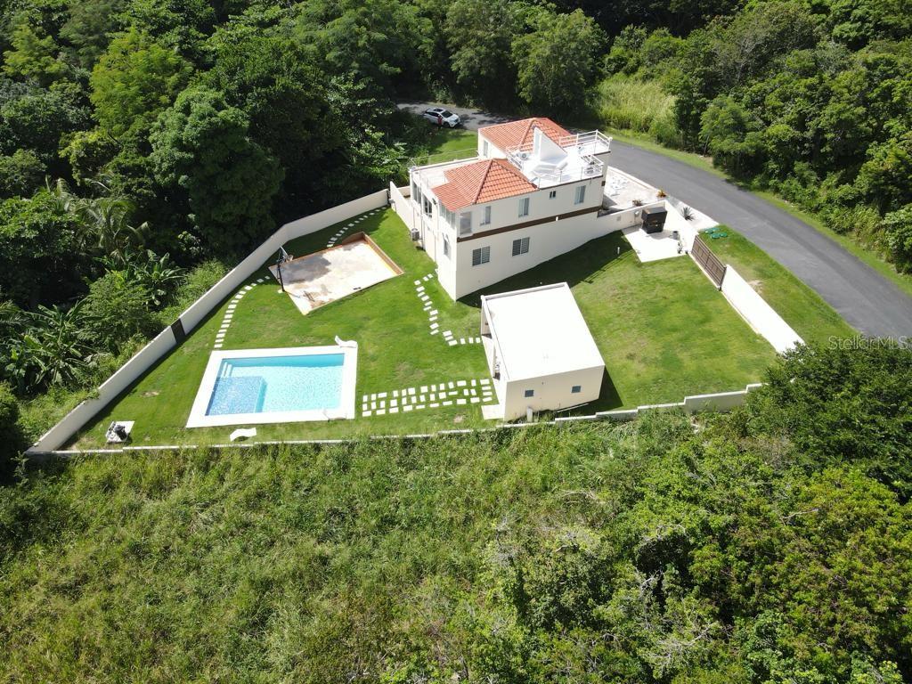 An aerial view shows a house with a pool, a detached building, and a basketball court — 40 ROBLE VALLEY UNIT 40, HUMACAO, PR