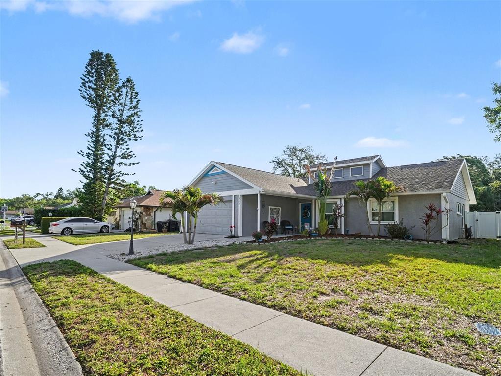 A single-story house with gray siding, a two-car garage, and a front lawn — 5627 35TH COURT E, BRADENTON, FL