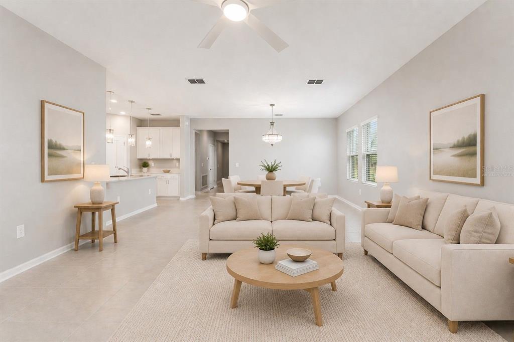 This virtually staged open-concept living and dining area features light tile flooring and neutral furniture — 3012 NAMASTE DRIVE, CLERMONT, FL