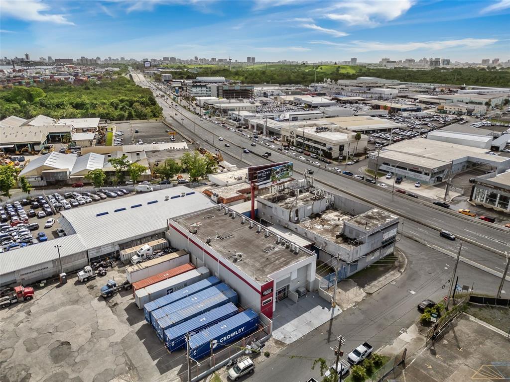 An aerial view shows a commercial building with shipping containers and a parking lot nearby — 168-198 CALLE MONTERREY, SAN JUAN, PR