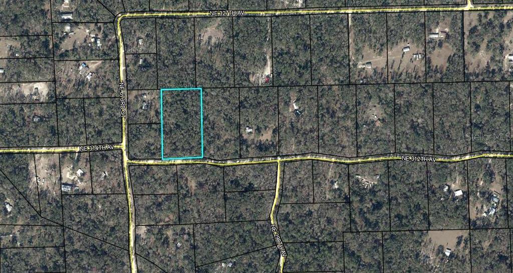 An aerial map shows a rectangular plot of land highlighted in blue among wooded lots — NE 312TH AVENUE, OLD TOWN, FL