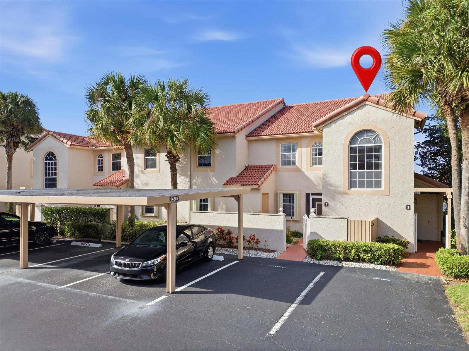 A two-story townhouse with a red tile roof, arched windows, and a covered parking area — 14383 Via Royal # 3, Delray Beach FL 33446, DELRAY BEACH, FL