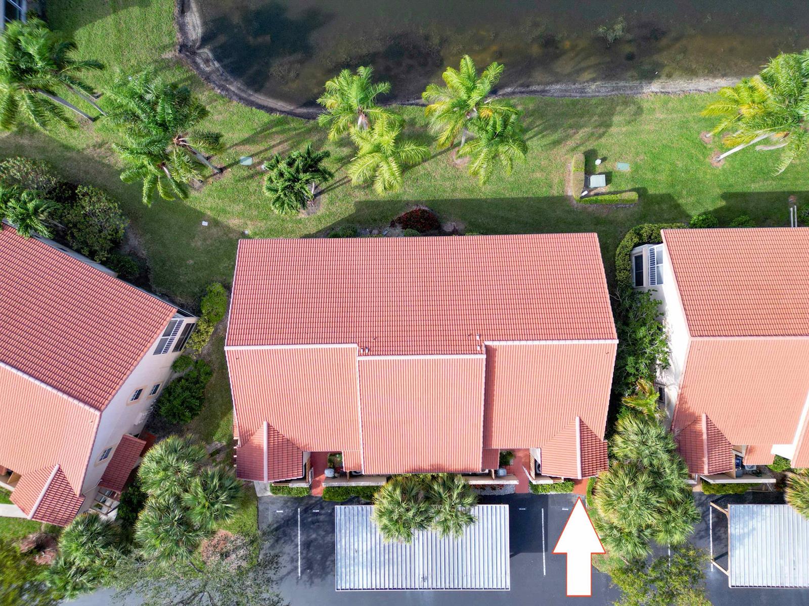 An aerial view shows a residential building with a red tile roof and parking area — 14383 Via Royal # 3, Delray Beach FL 33446, DELRAY BEACH, FL