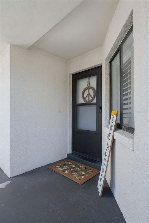 A multi-story apartment building with a covered parking area featuring several parked vehicles — 4109 FAIRVIEW VISTA POINT UNIT 114, ORLANDO, FL