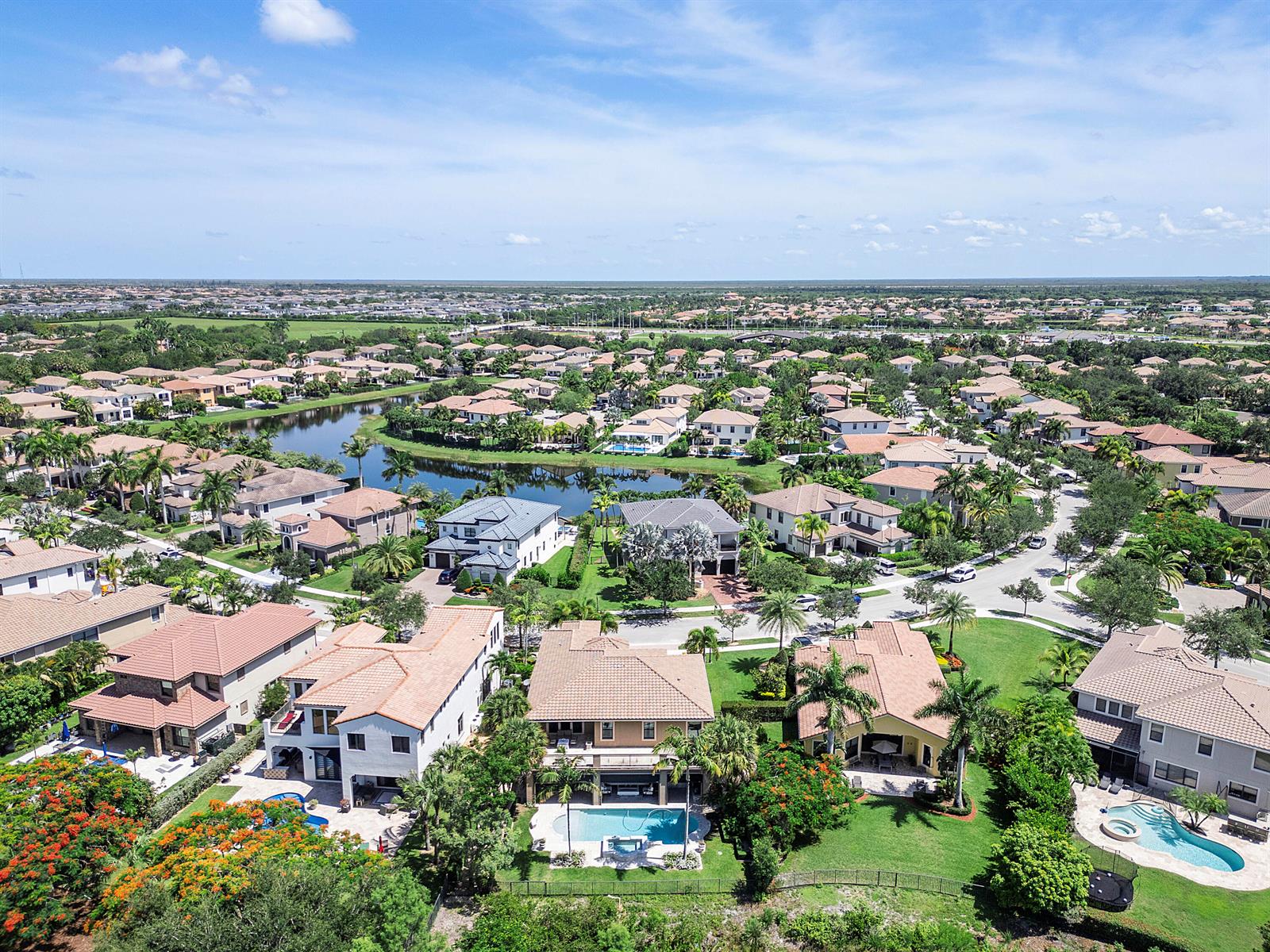 An aerial view of a suburban neighborhood featuring houses with tile roofs and swimming pools — 10282 Emerson Street, Parkland FL 33076, PARKLAND, FL