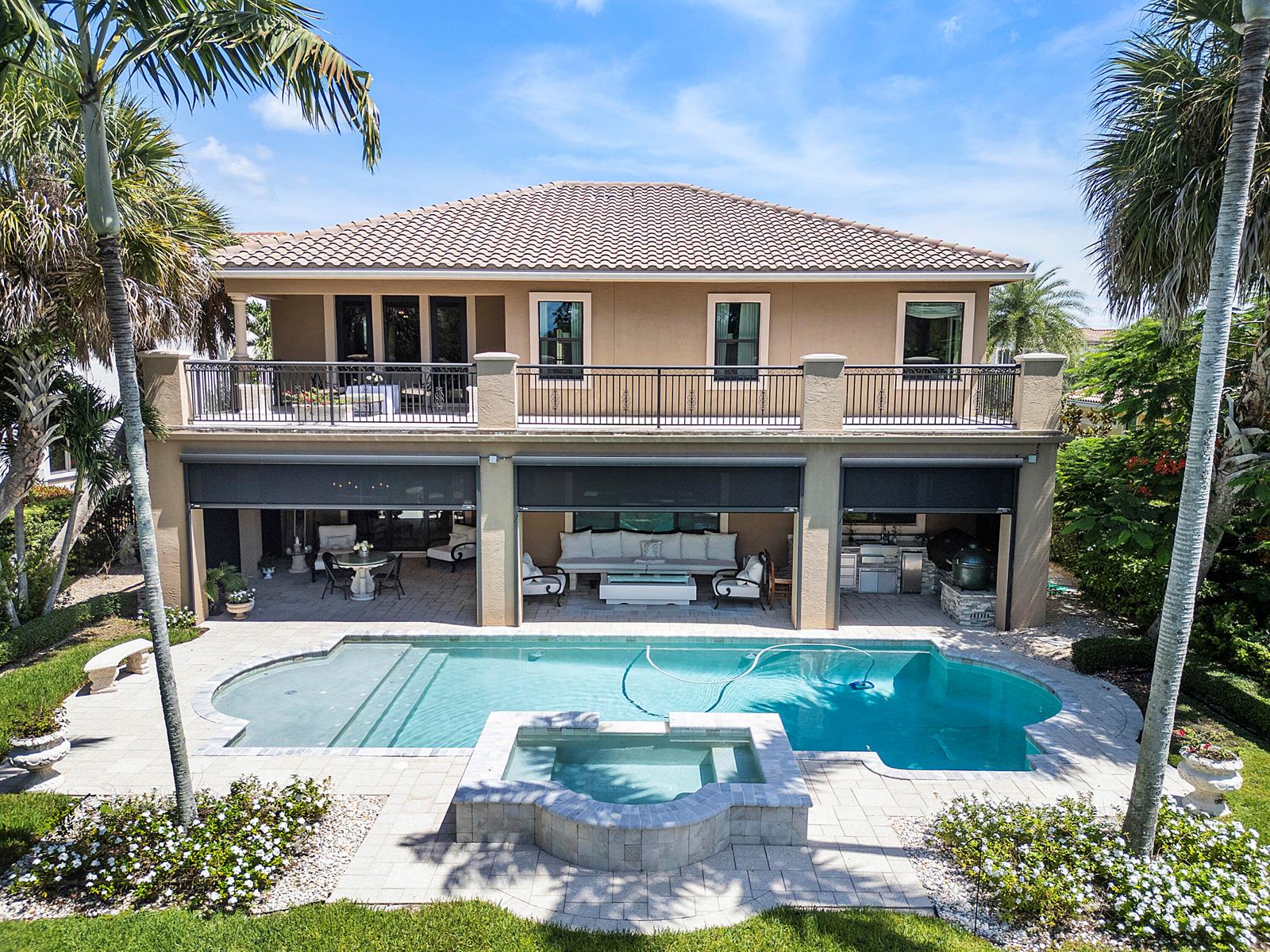 A two-story house features a covered patio, swimming pool, and spa in the backyard — 10282 Emerson Street, Parkland FL 33076, PARKLAND, FL