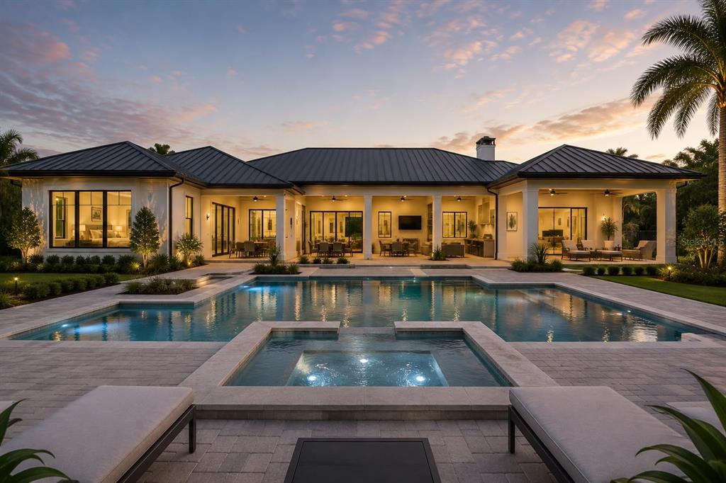 A modern house exterior features a swimming pool, a spa, and a covered patio at dusk — 10623 LITHIA ESTATES DRIVE, LITHIA, FL