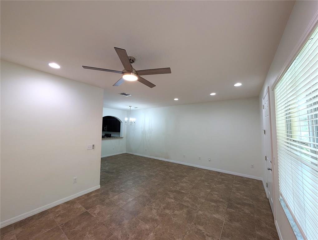 An empty room with tile flooring, a ceiling fan, recessed lighting, and a window with blinds — 14161 STOWBRIDGE AVENUE, TAMPA, FL
