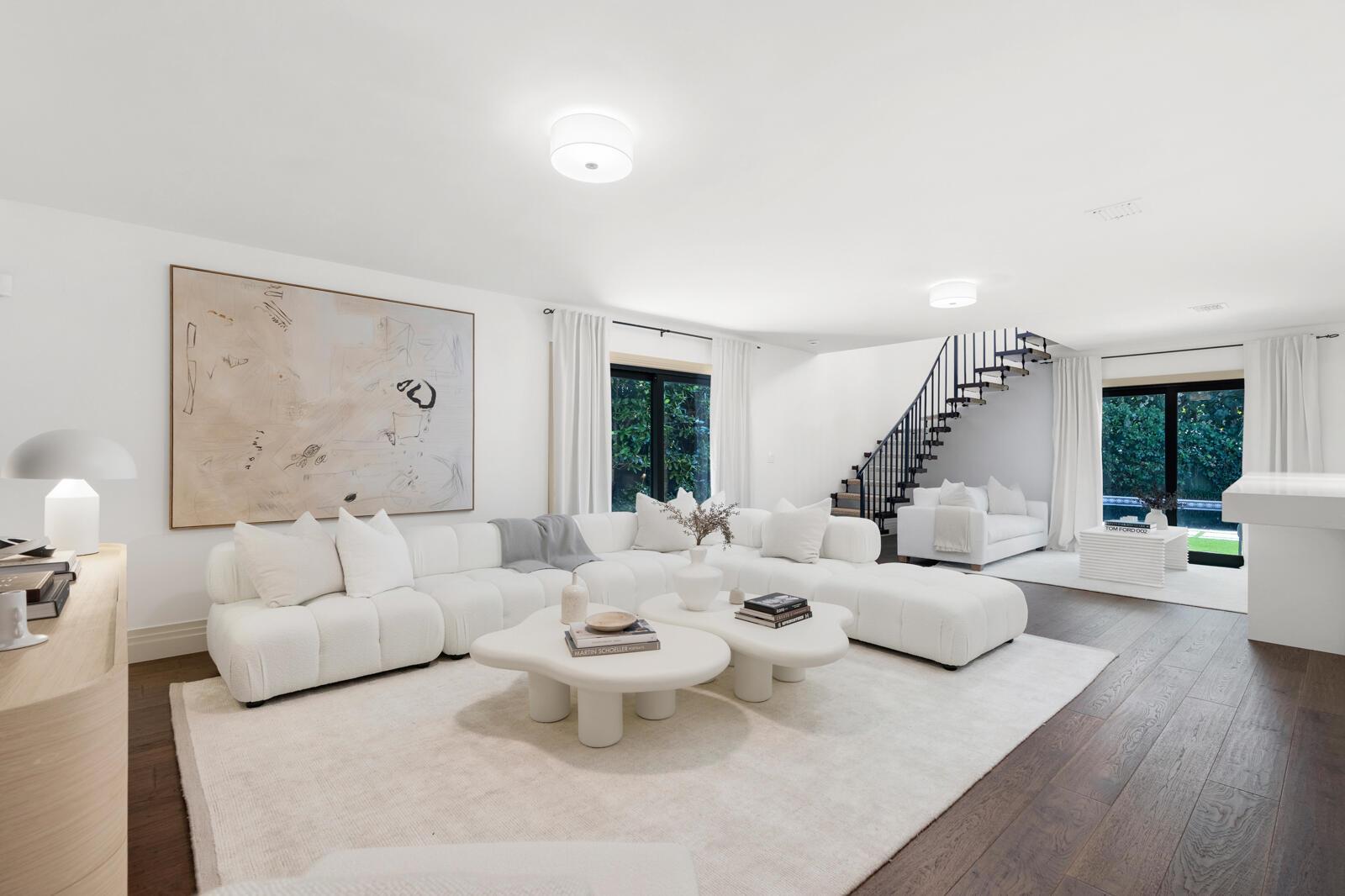 A bright living room features a white sectional sofa, two coffee tables, and a staircase — 1435 N Ocean Way, Palm Beach FL 33480, PALM BEACH, FL