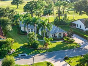 An aerial view shows a single-story house with a gray roof surrounded by palm trees — 3210 Bent Pine Drive, Fort Pierce FL 34951, FORT PIERCE, FL