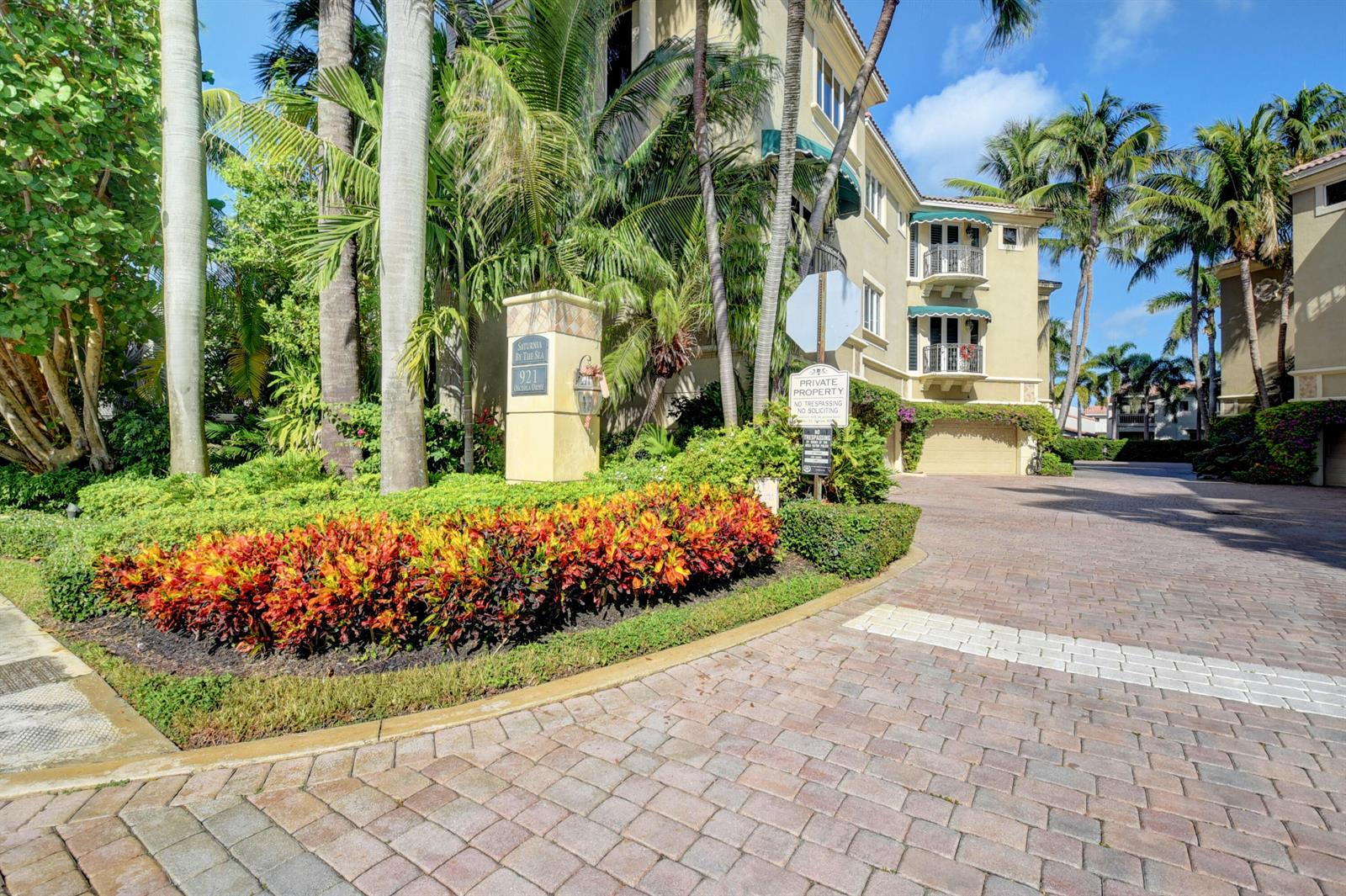 A paved driveway leads to a multi-story residential building surrounded by palm trees and landscaping — 921 Osceola Drive Unit 4, Boca Raton FL 33432, BOCA RATON, FL