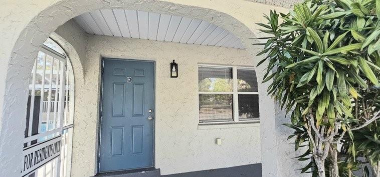 An exterior view of a blue front door marked with the letter E — 4387 JACKSON STREET UNIT J-E, PORT CHARLOTTE, FL