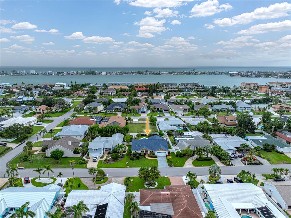 An aerial view shows a residential neighborhood with a blue-roofed house marked by an arrow — 366 6TH AVENUE N, TIERRA VERDE, FL