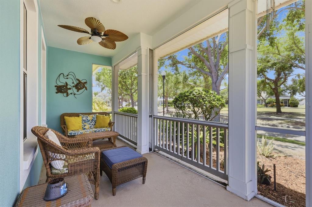 A screened-in porch with wicker furniture, a ceiling fan, and light blue walls — 5318 GOLDEN ISLES DRIVE, APOLLO BEACH, FL