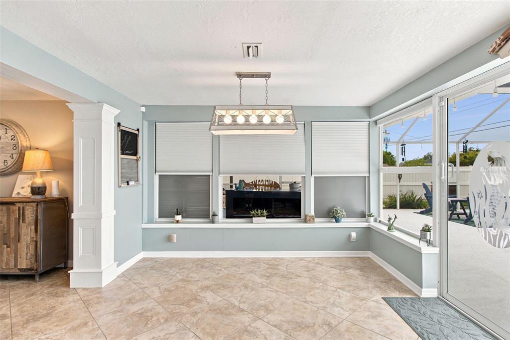 A living room features a sectional sofa, a floral area rug, and a ceiling fan — 415 BRIARWOOD ROAD, VENICE, FL