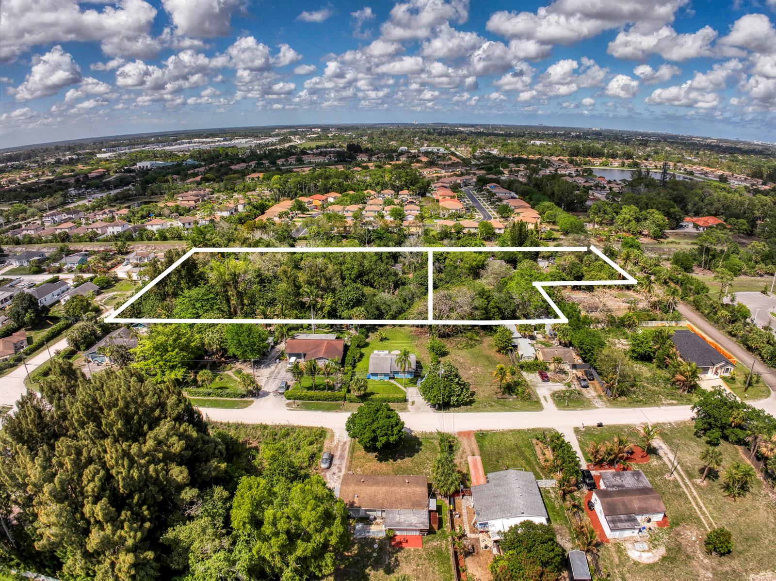 An aerial view shows a large, wooded, rectangular plot of land outlined in white — 470 63rd Trail N, West Palm Beach FL 33413, WEST PALM BEACH, FL