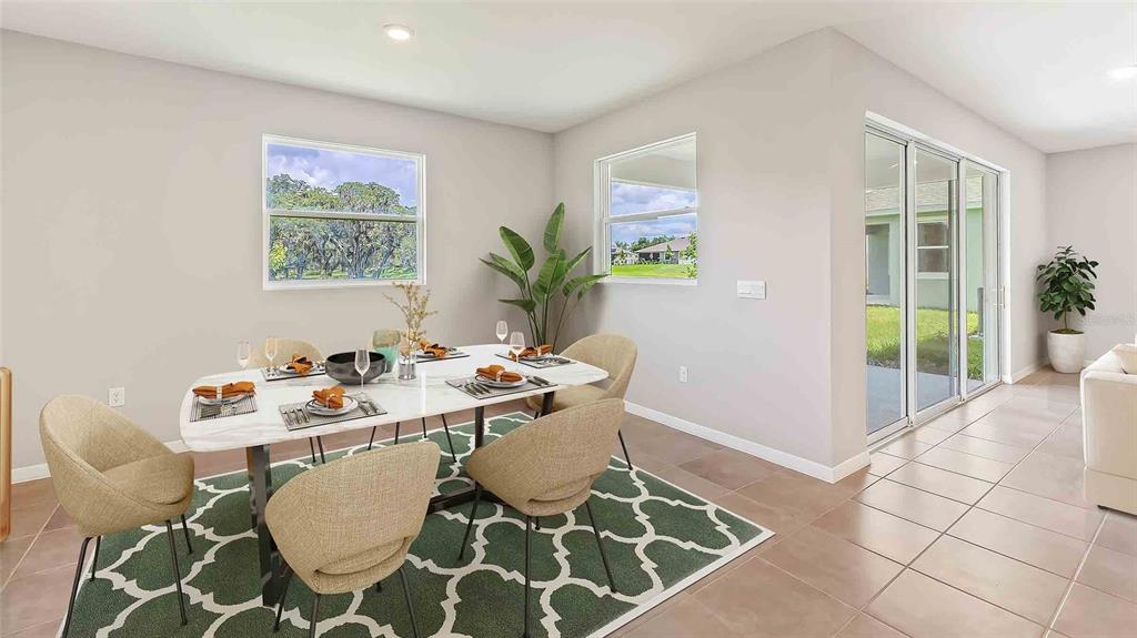 A dining area features a marble-topped table, upholstered chairs, a patterned rug, and sliding doors — 3516 HAZY GLEN LANE, PLANT CITY, FL
