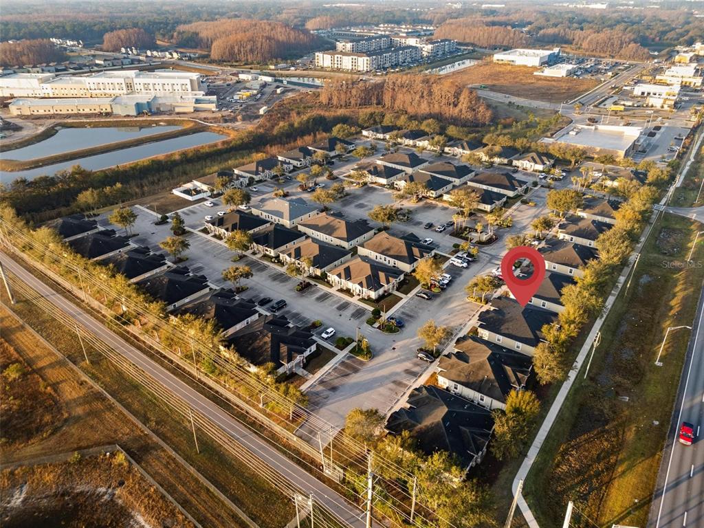 An aerial view shows a residential neighborhood with a red location pin on a house — 17929 HUNTING BOW CIRCLE UNIT 101 & 102, LUTZ, FL