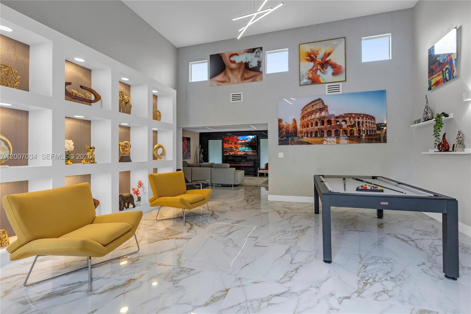 A spacious room features a pool table, two yellow chairs, and built-in display shelving — 13540 SW 98th Ct, Miami FL 33176, MIAMI, FL