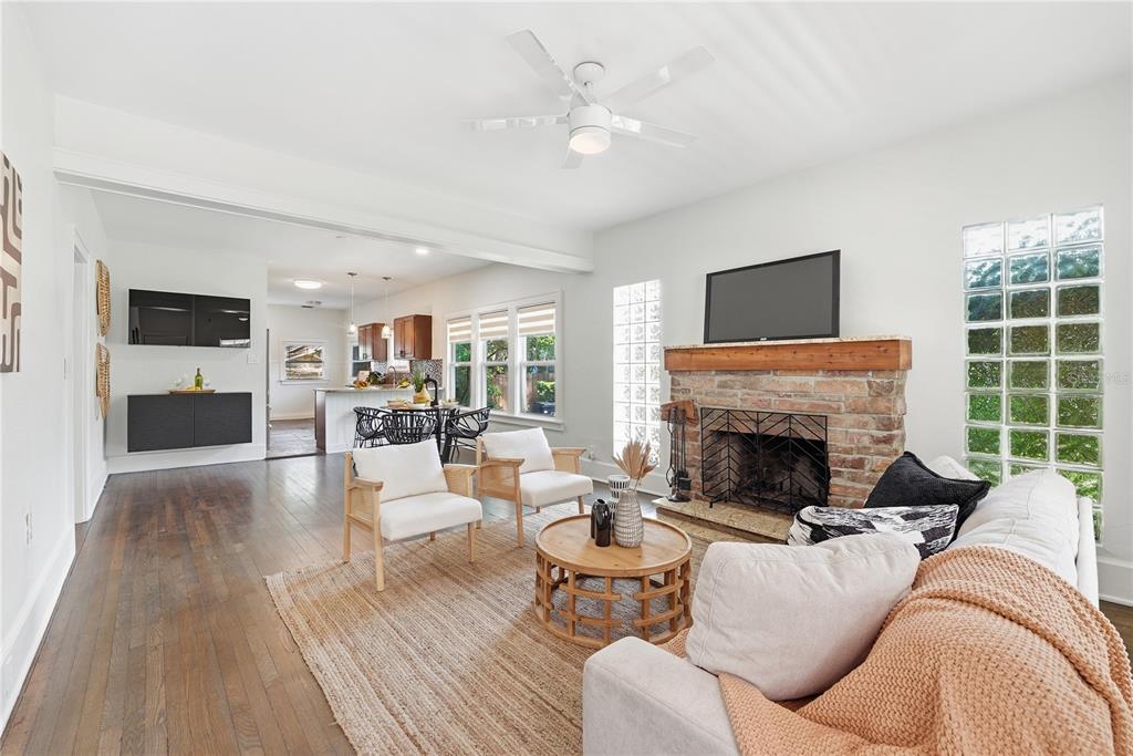 A living room features a brick fireplace, glass block windows, and hardwood floors — 204 N BROWN AVENUE, ORLANDO, FL