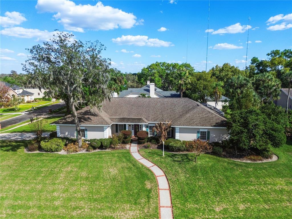 An aerial view shows a single-story house with a shingled roof and a front walkway — 10002 HUNT CLIFF DRIVE, RIVERVIEW, FL