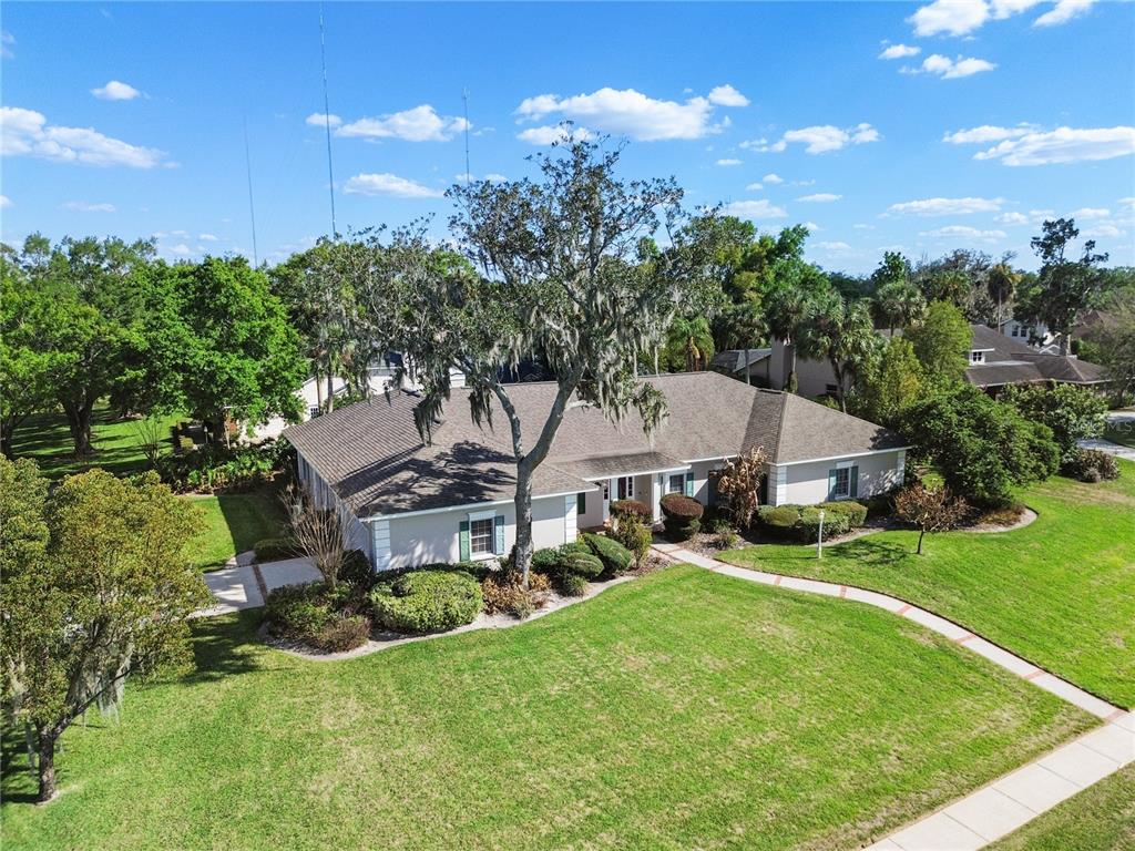An aerial view of a single-story house with a large tree in the front yard — 10002 HUNT CLIFF DRIVE, RIVERVIEW, FL