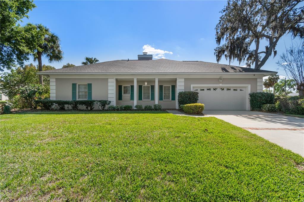 A single-story house with a gray exterior, green shutters, and an attached two-car garage — 10002 HUNT CLIFF DRIVE, RIVERVIEW, FL