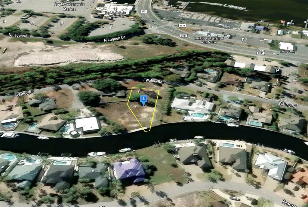 This is an aerial map view of a vacant waterfront lot highlighted in yellow — 475 WAHOO ROAD, PANAMA CITY BEACH, FL
