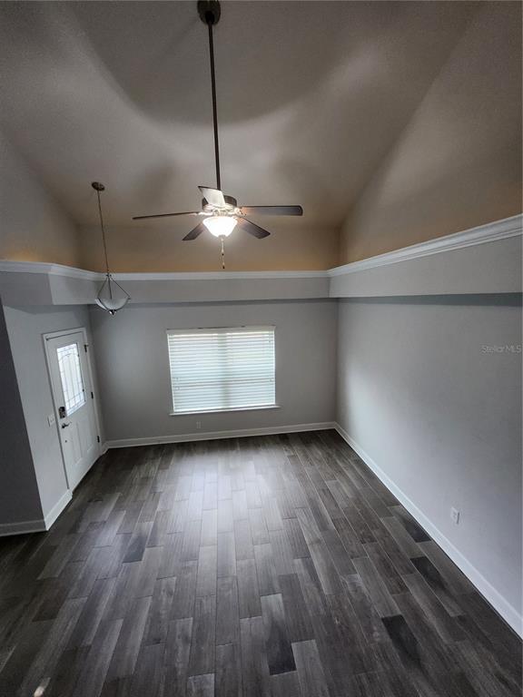 A room with high vaulted ceilings, a ceiling fan, gray walls, and dark wood-look flooring — 5179 NW 22ND STREET, GAINESVILLE, FL
