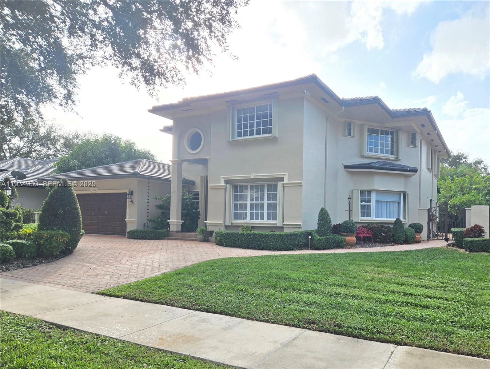 A two-story house with a beige stucco exterior, a tiled roof, and a paved driveway — 16422 NW 83rd Pl, Miami Lakes FL 33016, MIAMI LAKES, FL