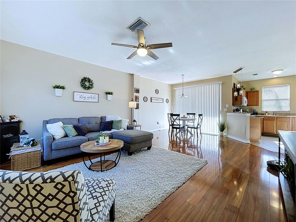 An aerial view shows a multi-unit townhouse complex with parking lots and surrounding green space — 12207 COUNTRY WHITE CIRCLE, TAMPA, FL