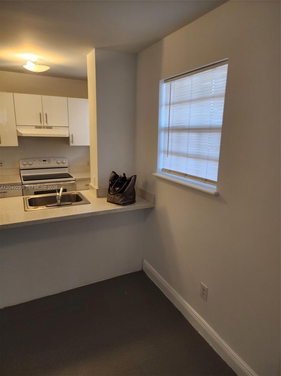 A kitchen features white cabinets, a stainless steel sink, and a window with blinds — 14240 NW 22nd Ave # 3, Opa-Locka FL 33054, OPA-LOCKA, FL