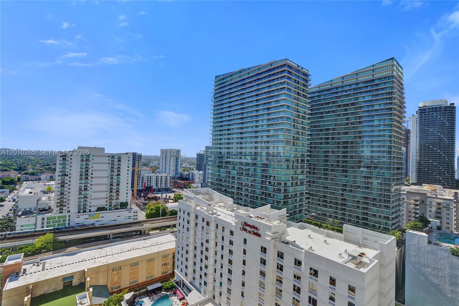 An elevated view shows several high-rise buildings, a Hampton Inn, and a nearby train track — 1250 S Miami Ave # 2103, Miami FL 33130, MIAMI, FL