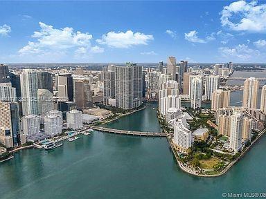 An aerial view of the Miami skyline featuring high-rise buildings surrounding a body of water — 888 Brickell Key Dr # 600, Miami FL 33131, MIAMI, FL