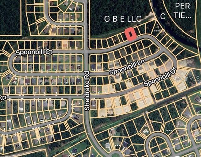 This is a satellite map view showing a residential lot highlighted in red — 274 SPOONBILL DRIVE, KISSIMMEE, FL