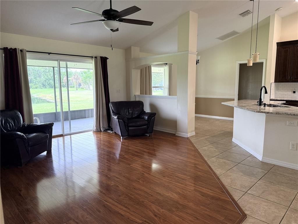 The exterior of a house features a covered entryway, two dark columns, and arched windows — 3338 GATOR BAY CREEK BOULEVARD, ST CLOUD, FL