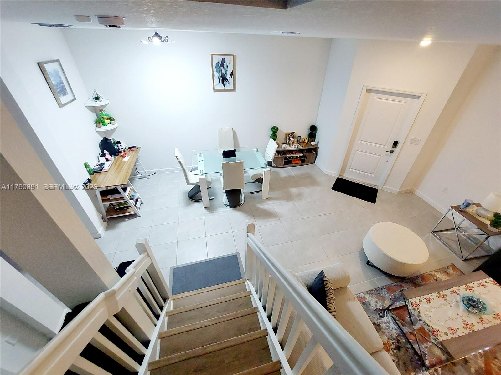 An elevated view shows a dining area, a workspace, and a living room with stairs — 12234 NW 23rd Path, Miami FL 33167, MIAMI, FL