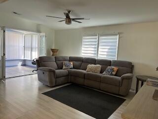 A living room features a large gray sectional sofa, a dark rug, and a ceiling fan — 5343 NW 4th Terrace, Deerfield Beach FL 33064, DEERFIELD BEACH, FL