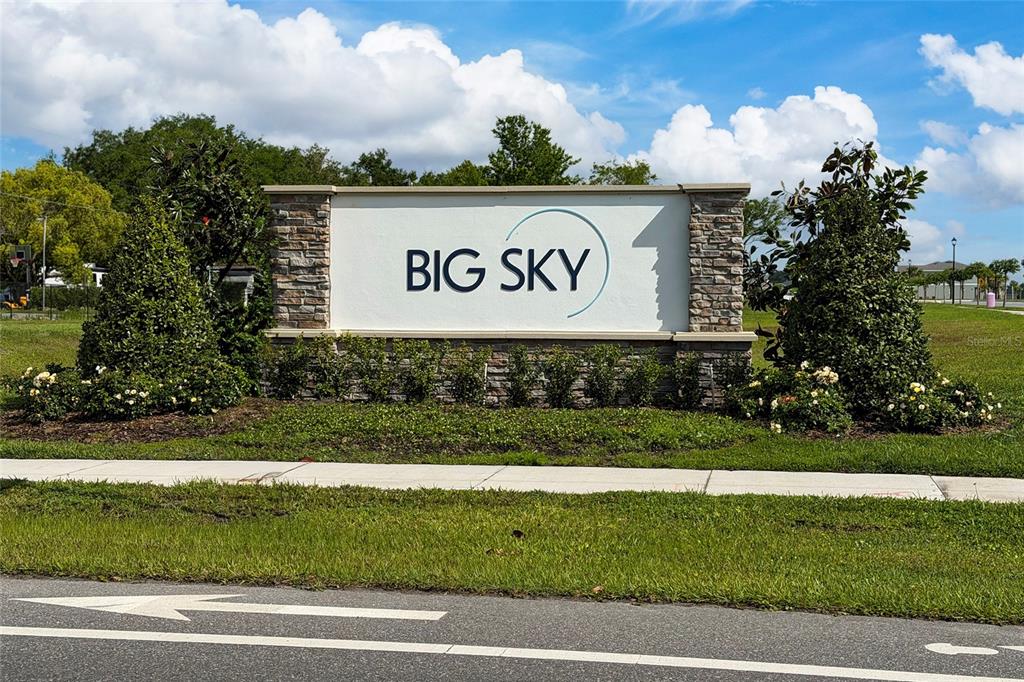 A stone-accented monument sign for Big Sky stands in a grassy area near a road — 1491 AUGUST GRAY DRIVE, KISSIMMEE, FL