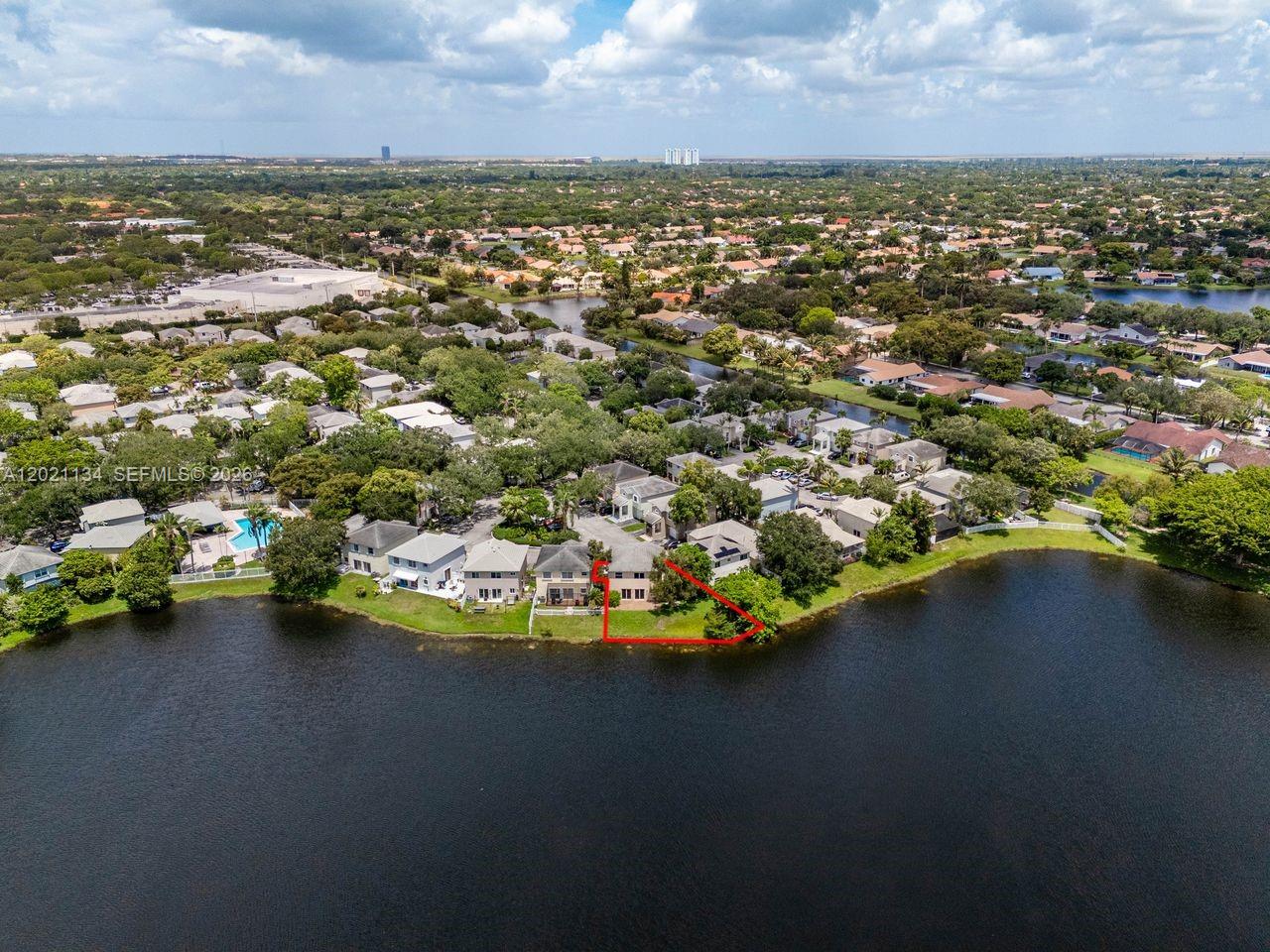An aerial view shows a residential house with a red-outlined yard bordering a lake — 850 NW 98th Ave, Plantation FL 33324, PLANTATION, FL