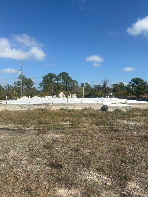 A concrete foundation slab for a new house sits on a cleared, grassy lot — 3 TAFFRAIL LANE, PLACIDA, FL