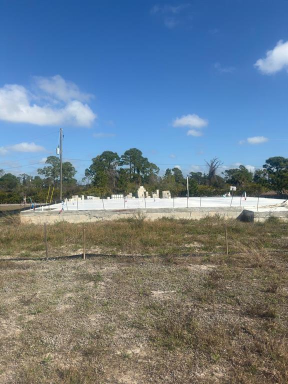 A concrete slab foundation for a new house sits on a cleared, grassy lot — 3 TAFFRAIL LANE, PLACIDA, FL