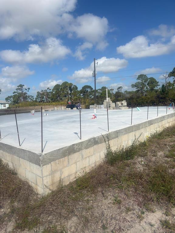 A concrete slab foundation with vertical rebar stands on a block stem wall at a site — 3 TAFFRAIL LANE, PLACIDA, FL