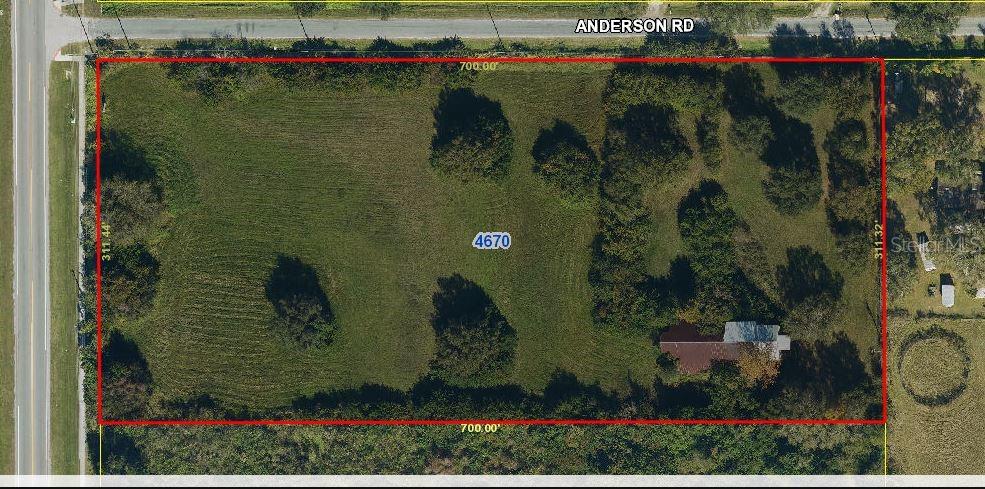 An aerial view shows a rectangular plot of land with a house and trees — 4670 ANDERSON ROAD, KISSIMMEE, FL