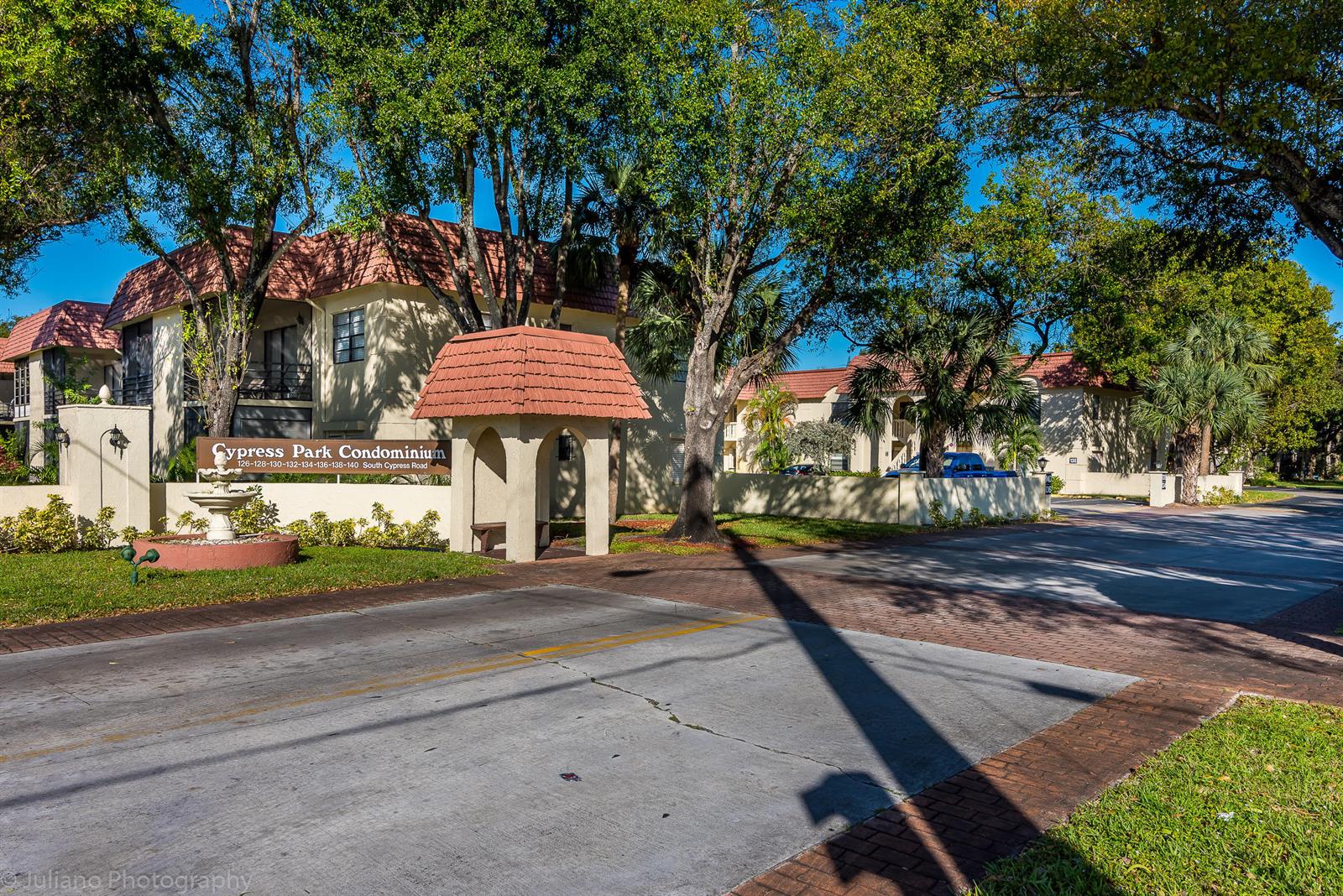 A sign for Cypress Park Condominium stands before a multi-story building with a tiled roof — 134 S Cypress Road # 425, Pompano Beach FL 33060, POMPANO BEACH, FL